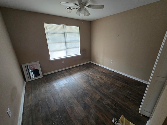 empty room featuring ceiling fan and dark hardwood / wood-style flooring