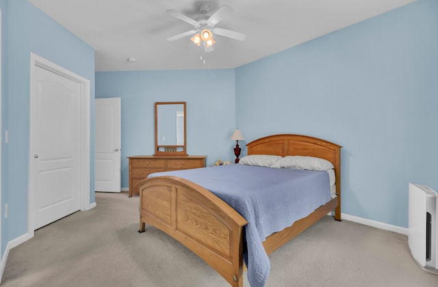 bedroom featuring light carpet and ceiling fan