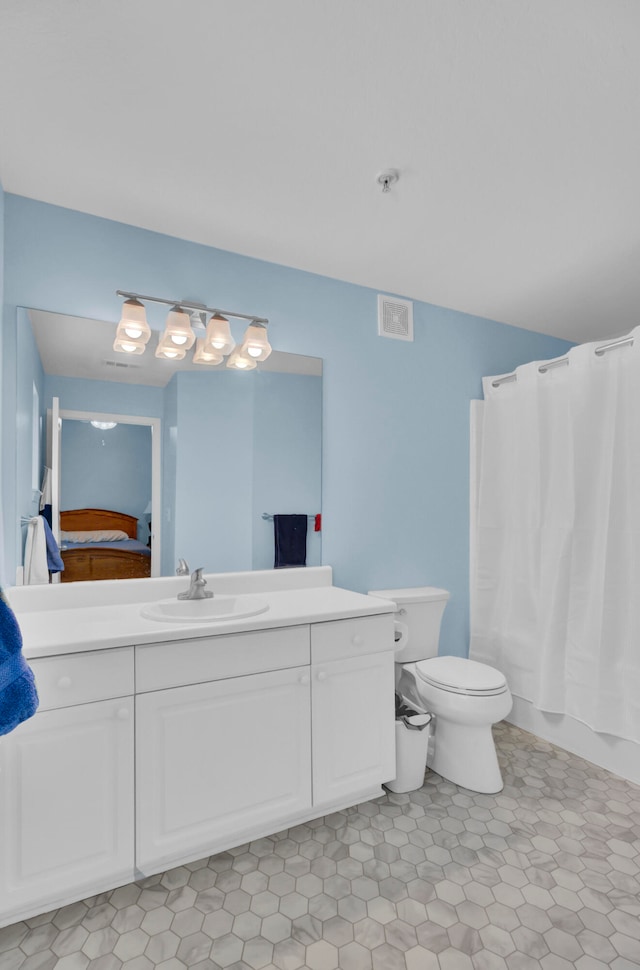 full bathroom with shower / bath combo with shower curtain, tile patterned flooring, vanity, and toilet