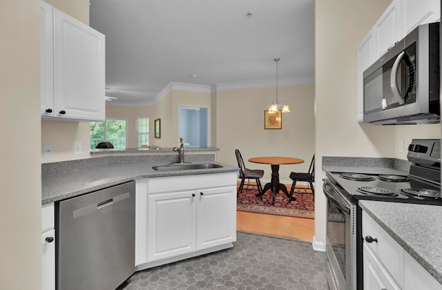 kitchen with stainless steel appliances, white cabinetry, sink, and ornamental molding