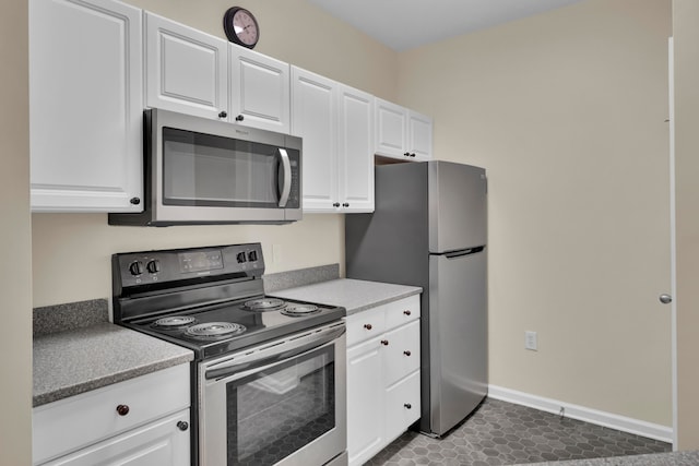 kitchen featuring white cabinets, appliances with stainless steel finishes, and tile patterned floors