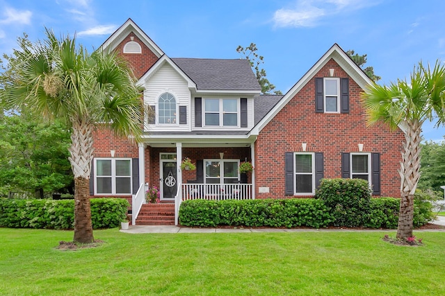 view of front facade featuring a front yard and covered porch