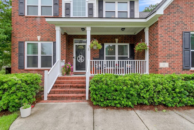 view of exterior entry featuring a porch