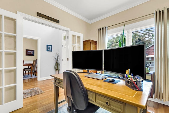 home office featuring crown molding and light hardwood / wood-style flooring