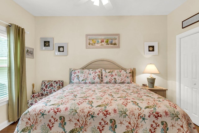 bedroom with hardwood / wood-style floors, a closet, and ceiling fan