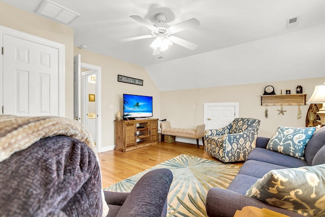 living room featuring vaulted ceiling, ceiling fan, and hardwood / wood-style floors