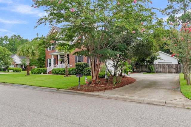 obstructed view of property featuring a front yard