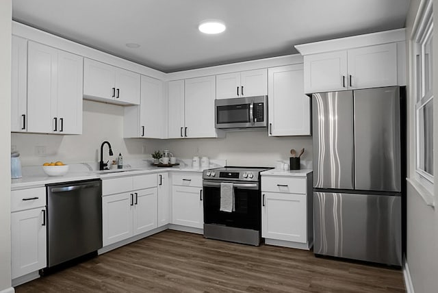 105 Brailsford Rd, Summerville, SC 29485 - kitchen featuring dark wood finished floors, light countertops, a sink, appliances with stainless steel finishes, and white cabinetry