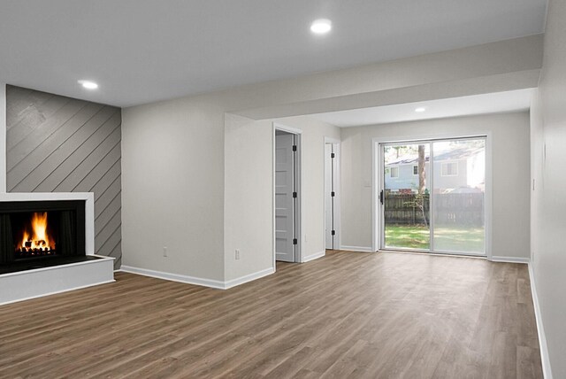 105 Brailsford Rd, Summerville, SC 29485 - unfurnished living room featuring baseboards, wood finished floors, and a large fireplace