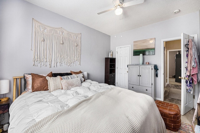 bedroom featuring a textured ceiling, vaulted ceiling, a closet, and ceiling fan