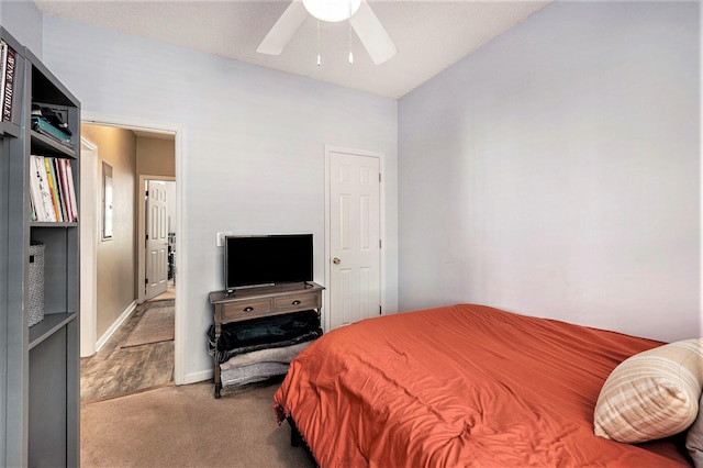 bedroom with ceiling fan, baseboards, and carpet