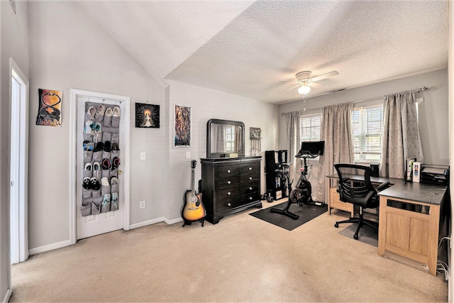 home office with lofted ceiling, a ceiling fan, a textured ceiling, carpet flooring, and baseboards