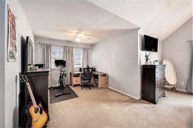 office featuring baseboards, vaulted ceiling, carpet floors, a textured ceiling, and a ceiling fan