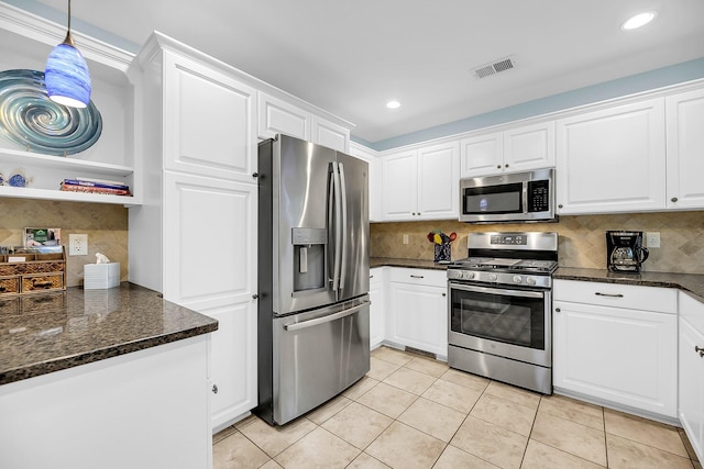 kitchen with light tile patterned flooring, white cabinetry, appliances with stainless steel finishes, tasteful backsplash, and pendant lighting