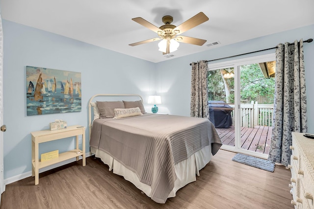 bedroom with access to outside, hardwood / wood-style floors, and ceiling fan