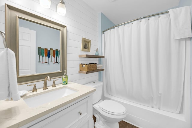 full bathroom with shower / bath combo, vanity, toilet, and wooden walls