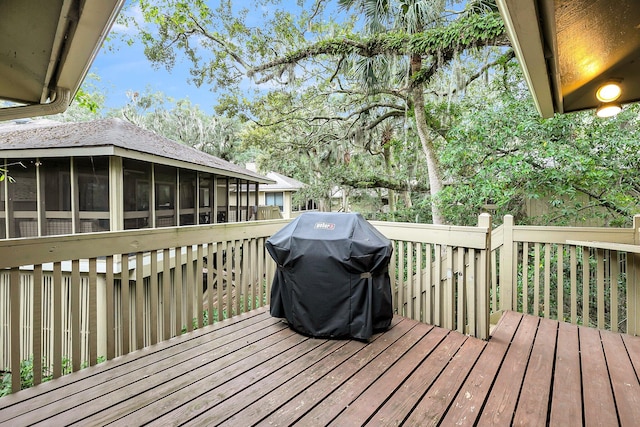 deck with a sunroom and a grill