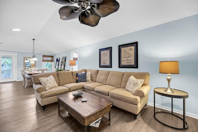 living room featuring lofted ceiling, hardwood / wood-style flooring, and ceiling fan