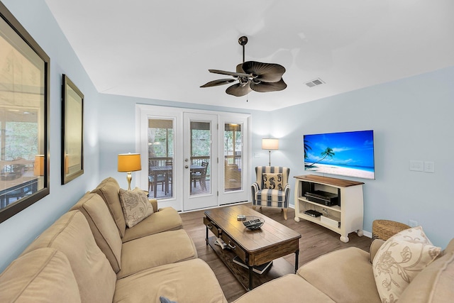 living room with ceiling fan and dark hardwood / wood-style floors