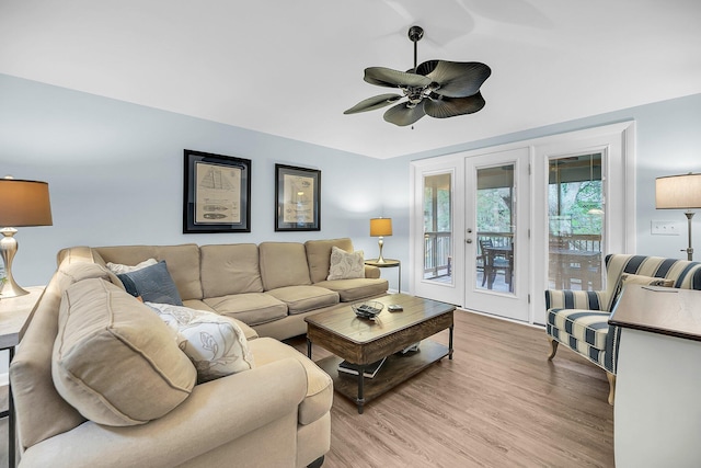 living room featuring ceiling fan and light wood-type flooring