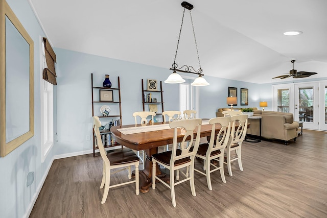 dining space featuring ceiling fan, wood-type flooring, french doors, and vaulted ceiling