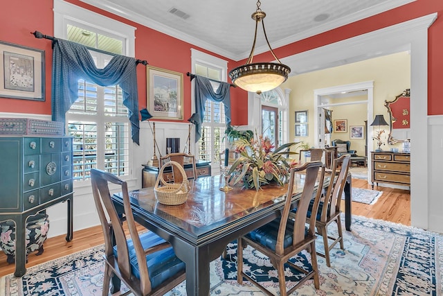 dining room featuring wood-type flooring and crown molding