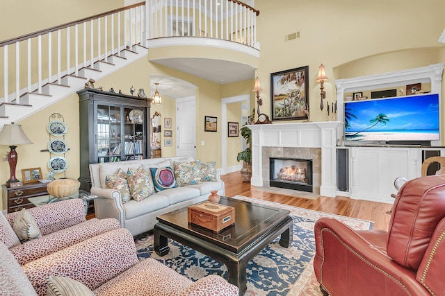 living room featuring wood-type flooring and a fireplace