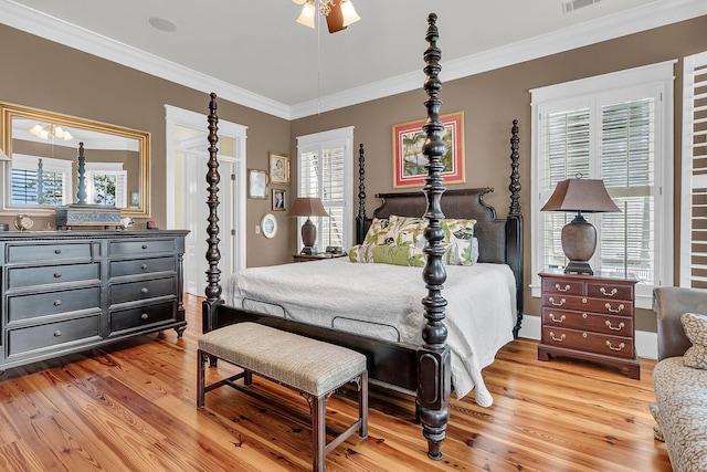 bedroom with crown molding, ceiling fan, and light wood-type flooring