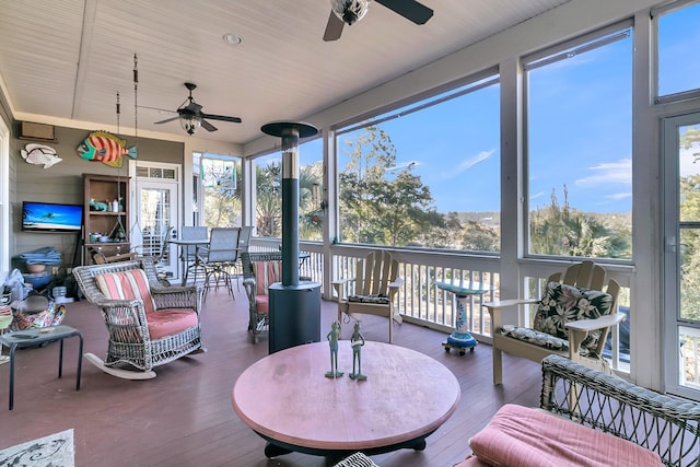 sunroom / solarium featuring ceiling fan