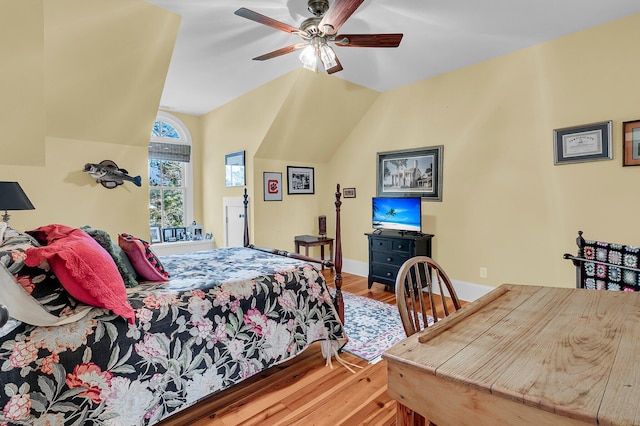 bedroom with hardwood / wood-style floors, vaulted ceiling, and ceiling fan