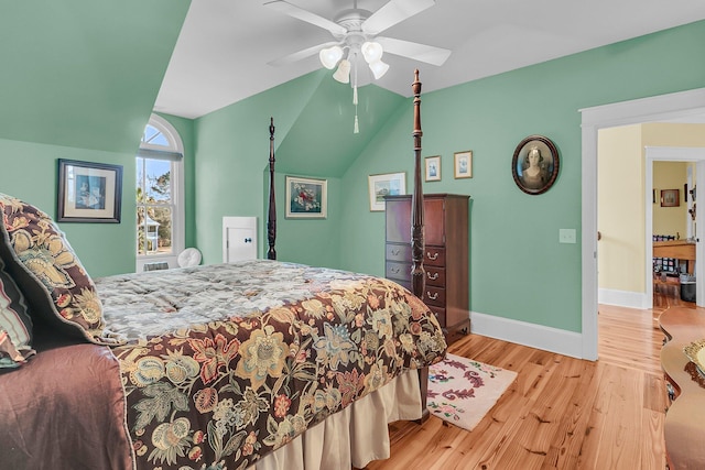 bedroom with vaulted ceiling, ceiling fan, and light wood-type flooring