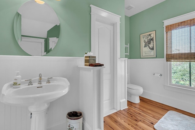 bathroom featuring wood-type flooring, sink, and toilet