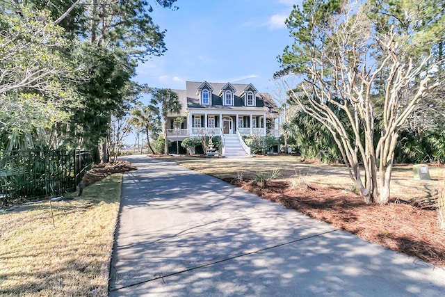 cape cod-style house featuring covered porch