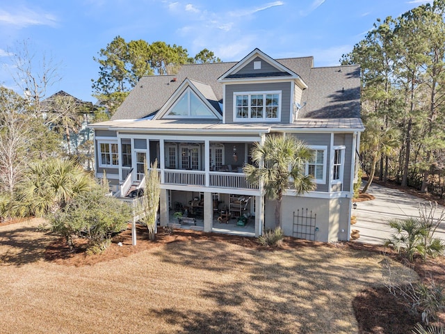 rear view of house with a patio and a sunroom