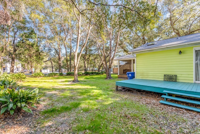 view of yard featuring a sunroom and a deck