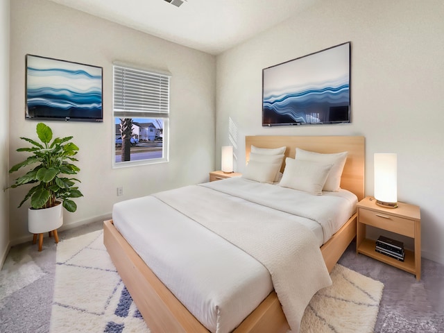 carpeted bedroom with baseboards