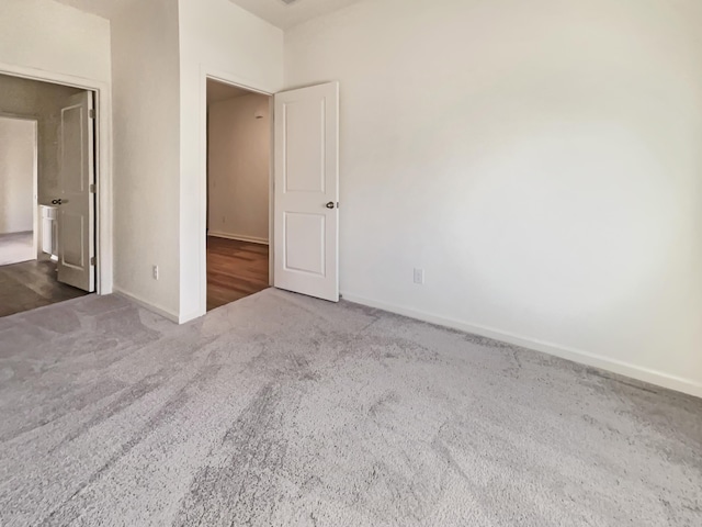 unfurnished bedroom with baseboards and carpet