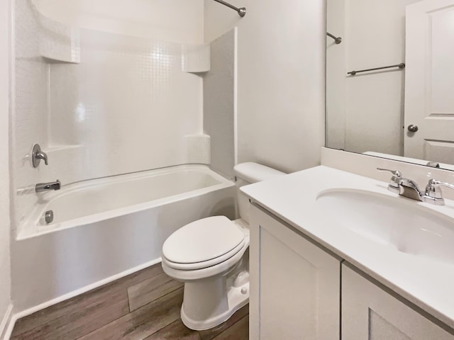 bathroom featuring shower / washtub combination, toilet, vanity, and wood finished floors