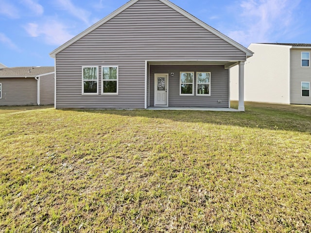 back of house featuring a patio and a yard