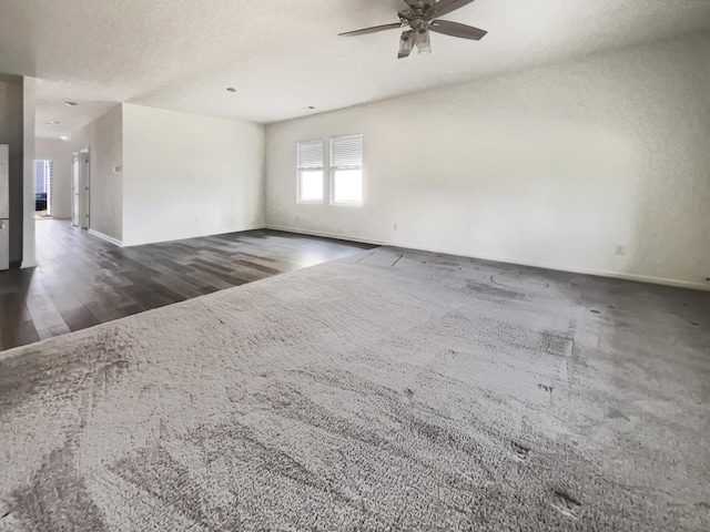 unfurnished room with baseboards, a ceiling fan, and wood finished floors