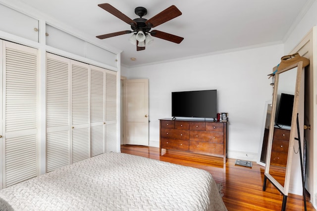 bedroom featuring ceiling fan, hardwood / wood-style flooring, and ornamental molding