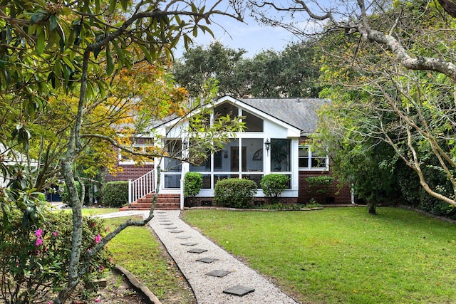 view of front of house featuring a front yard and a sunroom