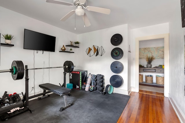 workout area featuring ceiling fan and dark hardwood / wood-style floors