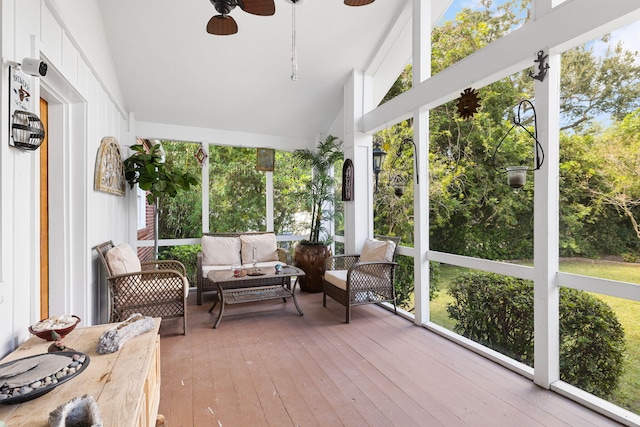 sunroom featuring lofted ceiling, ceiling fan, and plenty of natural light