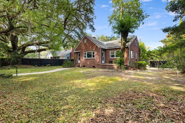 rear view of property with a lawn