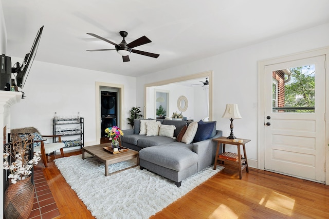 living room featuring wood-type flooring and ceiling fan