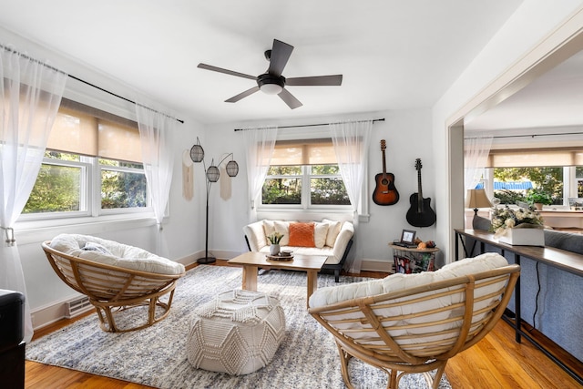 living room featuring ceiling fan and light hardwood / wood-style flooring