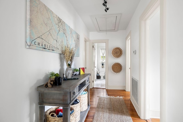 corridor with hardwood / wood-style flooring