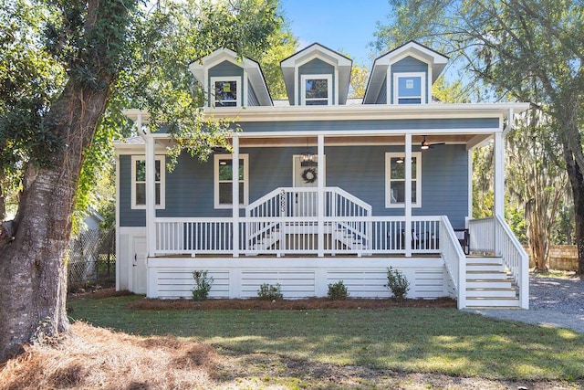 cape cod home featuring a front yard and a porch