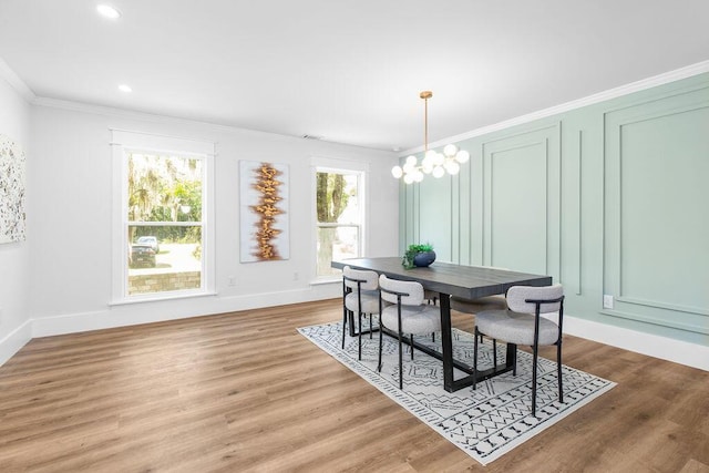 dining room with crown molding, a chandelier, and wood-type flooring